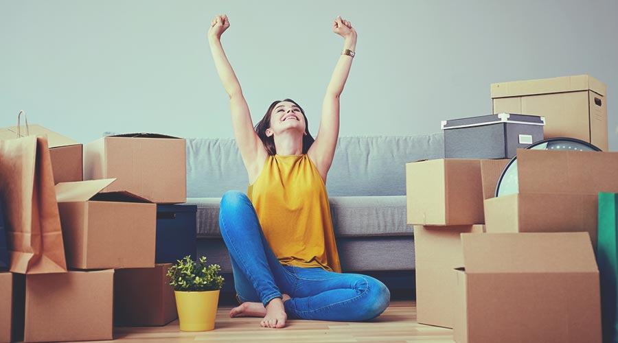 A happy woman in a rented flat