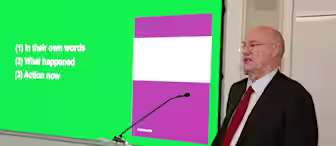 A man in a suit and red tie stands at a podium labeled "fieldfisher." He is giving a presentation in front of a screen displaying the slide title "SCOPE" with three bullet points: (1) In their own words (2) What happened (3) Action now.