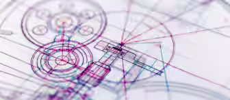 A close-up of a technical drawing or blueprint featuring intricate and overlapping lines, circles, and geometrical shapes in various colors like red, blue, and purple. The design appears complex, with mechanical and architectural elements intersecting.
