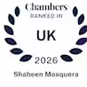 A dark blue laurel wreath surrounds the text: "Chambers Ranked In UK 2026 Shaheen Mosquera" on a white background.