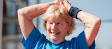 senior lady smiling with her hands above her head
