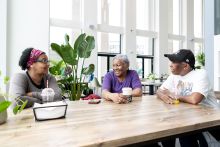 three women chatting at a table