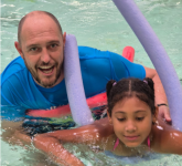 Swim lead Tim Smith with child