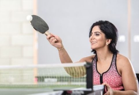 member in a wheelchair playing table tennis