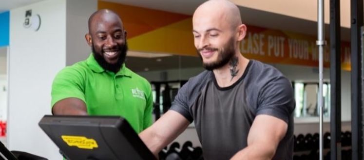 Fitness instructor completing a gym induction with customer.