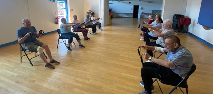 Participants of seated chair exercise taking part in a class.