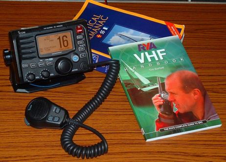 VHF Radio and course book on a table