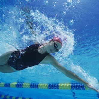 An image of a woman doing the front crawl in a fast lane