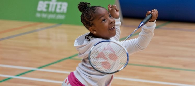 An image of a child playing badminton