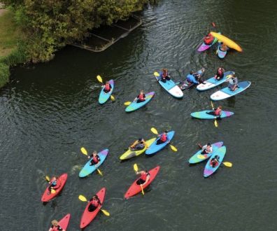 Ariel view of large group of kayakers on Stanborough Lake