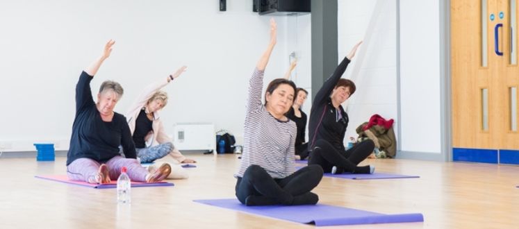 Senior participants taking part in a Yoga session