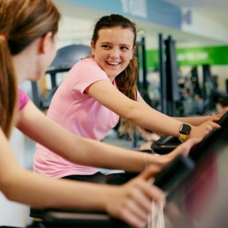 Girls on treadmill smiling