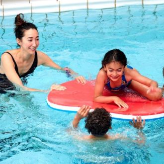 Family having fun with a pool float in the swimming pool at Southbury Leisure Centre