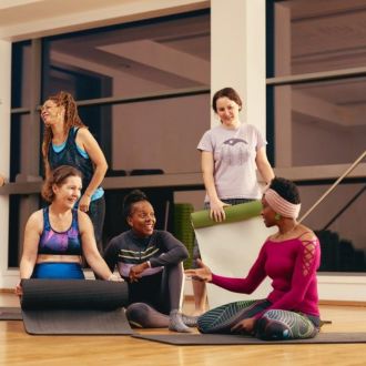A group getting ready for a Pilates class