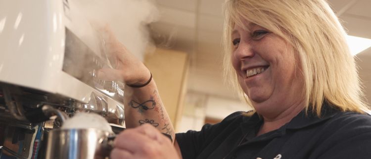 An image of a barista making a coffee