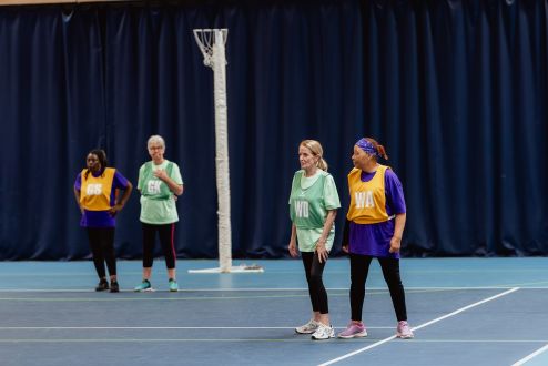 group of women playing netball in bibs