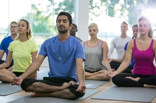 Adult group taking part in Yoga class 