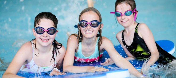 3 Children on a Pool mat wearing goggles and having fun