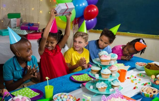 Children sat at table for birthday party celebrations
