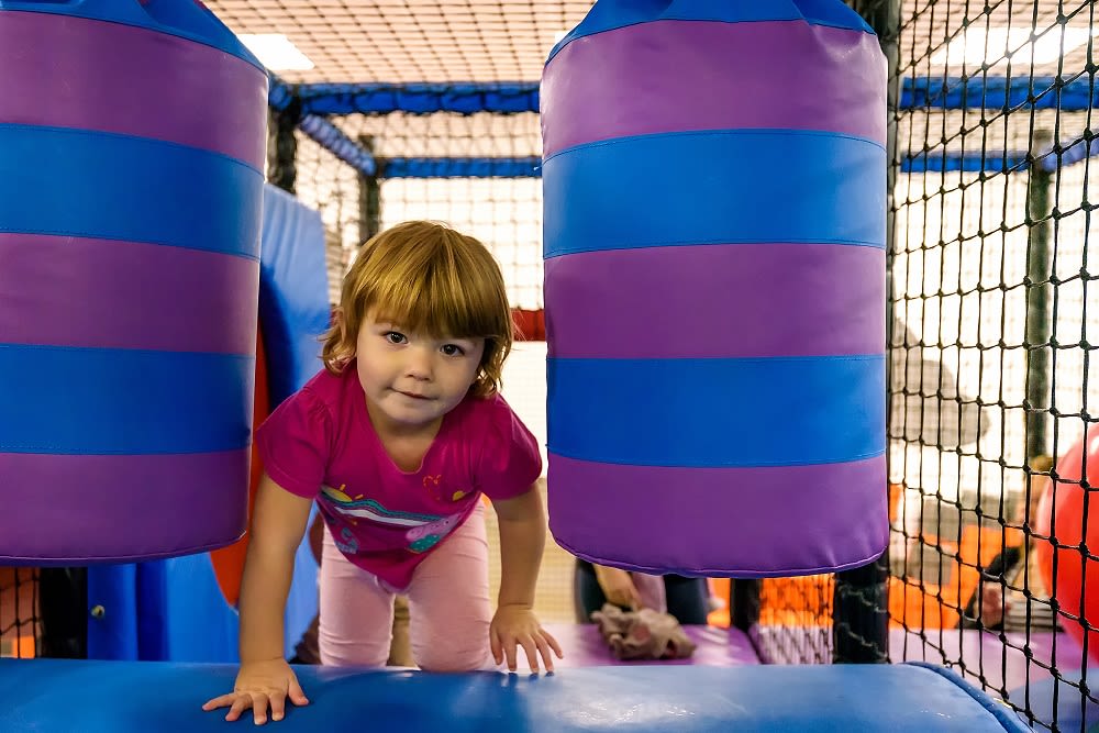 A girl enjoying exploring the Better Play area at Bath Sports and Leisure Centre