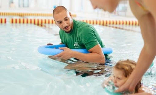 swim teacher with young child
