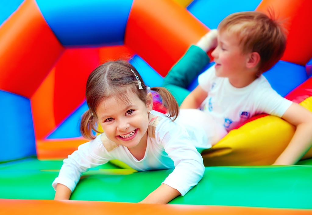 Children enjoying an inflatable party