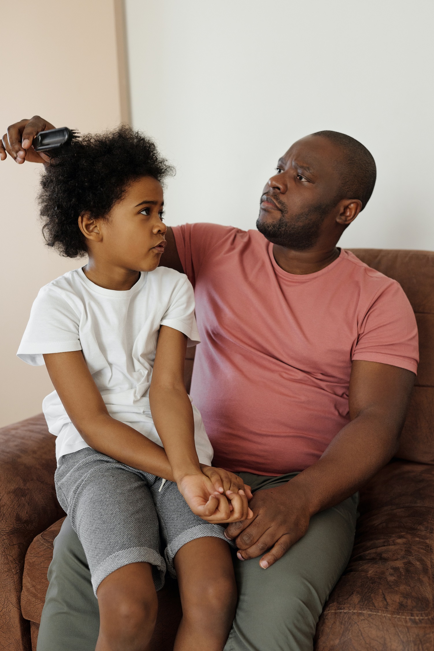 Father brushing his son s hair 4260103