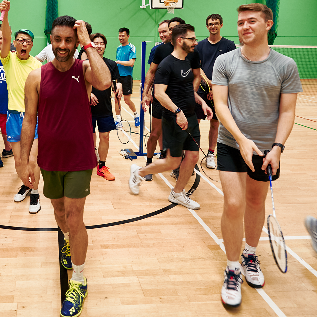 group playing badminton group playing badminton