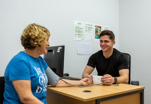 Health check within the gym with a fitness instructor Health check within the gym with a fitness instructor