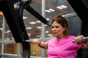 A woman working out at the gym using a exercise machine A woman working out at the gym using a exercise machine