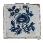 An Old Blue and White Ceramic Tile with a Flower On It
