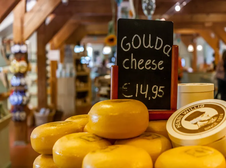 Rounds of Yellow Waxed Gouda Cheese in a Market