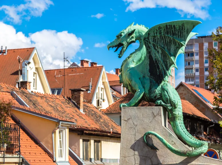 Statue of a Winged Dragon near Some Houses