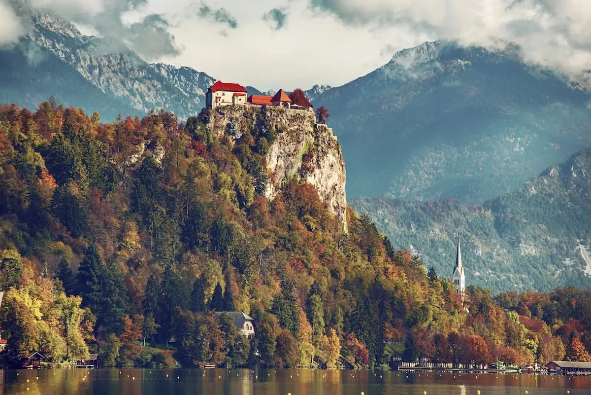 bled castle in autumn with lake and mountains