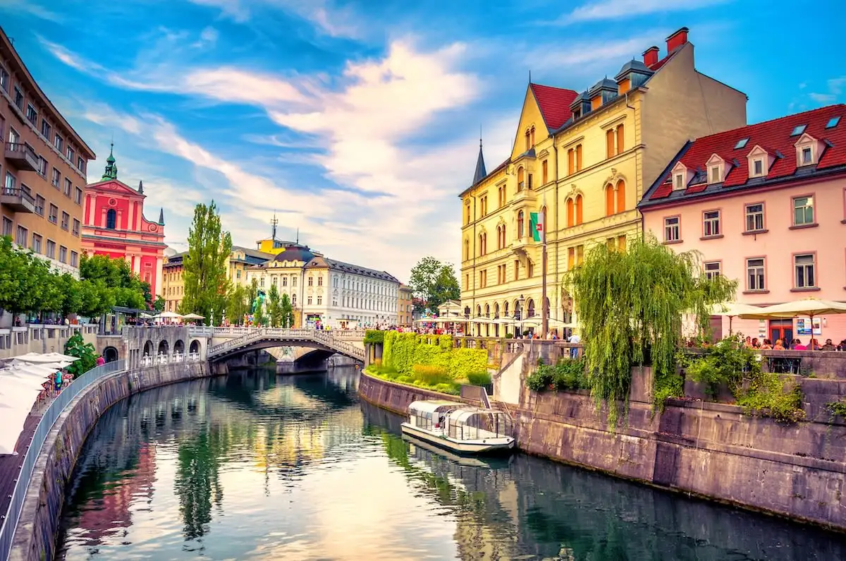 river with stone bridge and church in Ljubljana