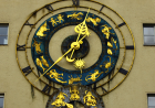 A Clock Face with Zodiac Signs in Gold 