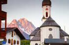 A Bavarian Style Church in Front of Mountains