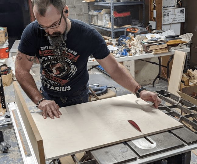 Picture of Michael Sean McDade operating a table saw like a champ