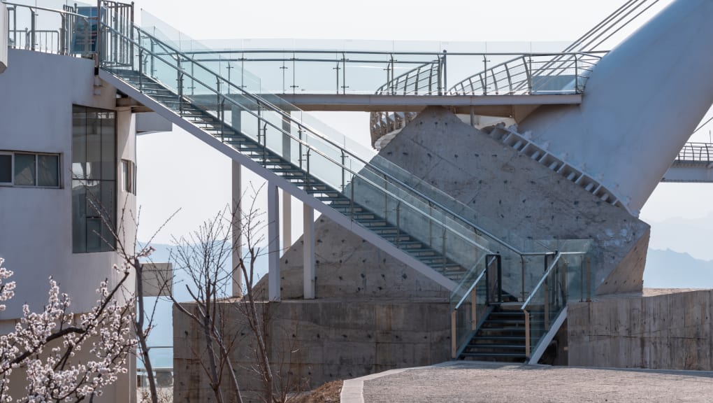 View of a staircase leading up to the Tanxishan glass landscape pedestrian bridge