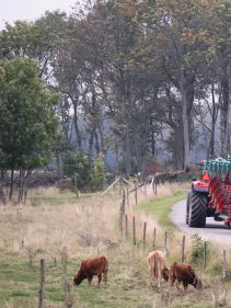 Packers - Kverneland Packomat compact and transported above ground level, dragged by tractor in a folded shape