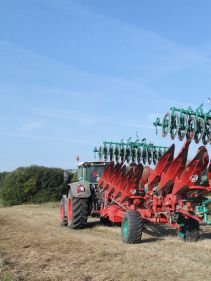 Packers - Kverneland Packomat compact and transported above ground level, dragged by tractor in a folded shape