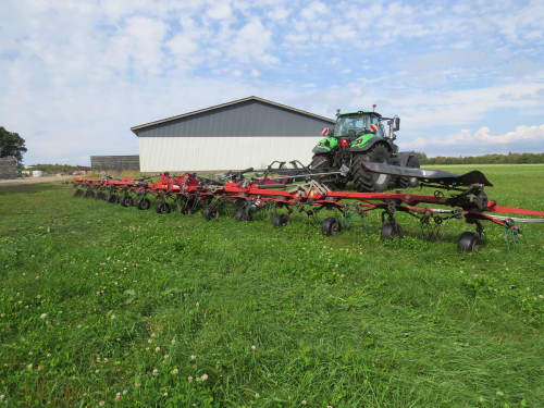 Kverneland 85156 tedder spreading grass for silage production at Hedegaarden dairy farm