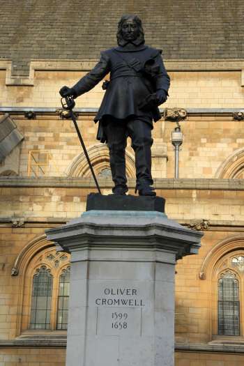 Oliver Cromwell overthrew King Charles I and made himself ruler of England. While he helped establish the principle of parliamentary rule, and proved the king was not above the law, Cromwell was also a bloodthirsty religious fanatic and a military dictator. His statue still stands outside the British Parliament today, mixed legacy notwithstanding. 
Image credit: Karen Roe via Flickr/Creative Commons
