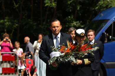 Prime Minister Tony Abbott carries flowers to place at the floral tribute to the victims of MH17 at Hilversum, Netherlands, 11 August 2014