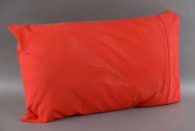Pillow in a red pillowcase from the Neville Bonner Collection