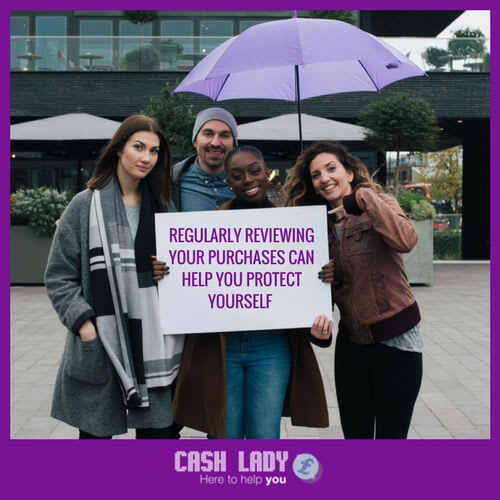 three happy people are standing under an umbrella and holding a banner