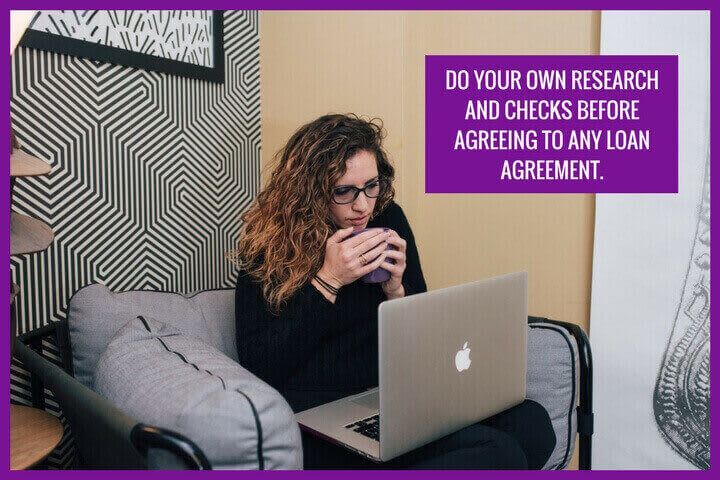 a pretty lady is sitting on the sofa with a laptop trying to apply for a loan