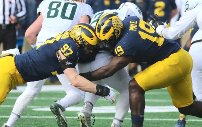 Michigan Wolverines football's Aidan Hutchinson (left) and Kwity Paye