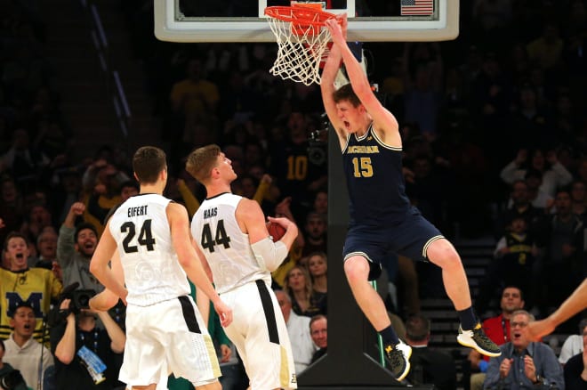 Michigan Wolverines basketball senior center Jon Teske yells.