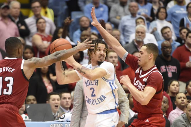 NC State fifth-year senior wing C.J. Bryce, left, and sophomore forward Jericole Hellems trap UNC freshman point guard Cole Anthony on Tuesday in Chapel Hill.